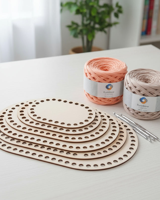 Yarn and crochet hooks on a white surface with a plant in the background